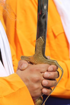 hands of a sikh man during the religious procession
