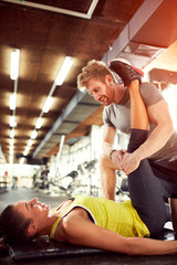 Fototapeta na wymiar Trainer help girl in exercises