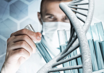 Young scientist mixing reagents in glass flask in clinical laboratory