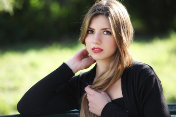 Smile blonde lying on green grass