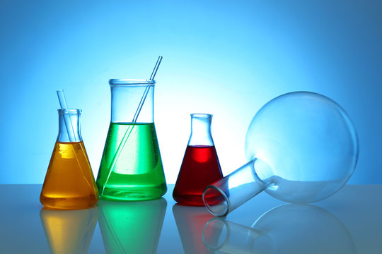 Test beakers and flasks on color background