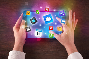 hands holding tablet