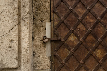 The old iron door is closed on the padlock. Riga. Latvia.