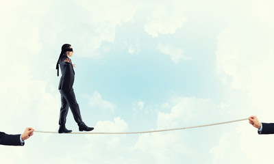 Obraz premium Business concept of risk support and assistance with man balancing on rope