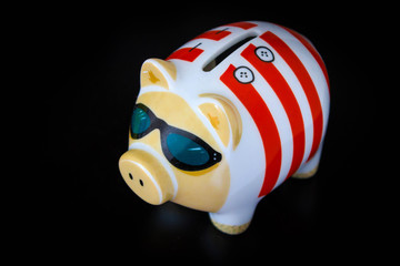 Piggy Bank with cool sunglasses on a black table