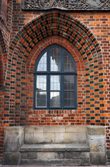 Fototapeta na wymiar Window in brick wall of Old Town Hall in Hannover, Germany.