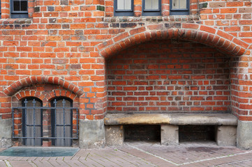 Stone bench in brick wall of Old Town Hall in Hannover, Germany.