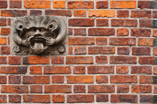 Ancient sculpture of devil on wall of Old Town Hall in Hannover, Germany. - Powered by Adobe