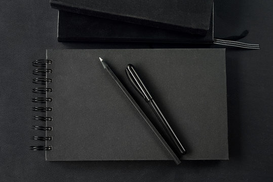Black notebook on black background