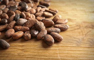 Aromatic cocoa beans on wooden table