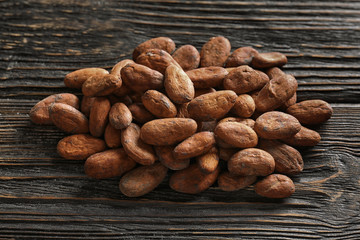 Aromatic cocoa beans on wooden table