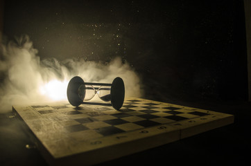 chess board game concept of business ideas and competition and strategy ideas concep. Chess figures on a dark background with smoke and fog.