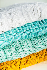 Fototapeta na wymiar Stack of Cozy Cotton Knitted Sweaters