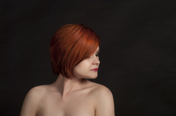 Portrait of a smiling girl on a dark background.