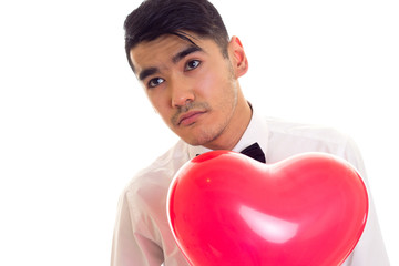 Young man with bow-tie holding balloon