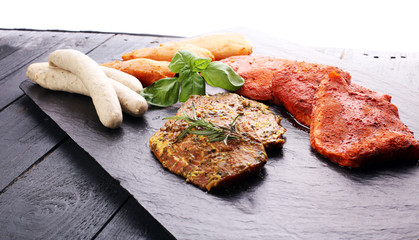 Selection of marinaded meat for grilling and sausages