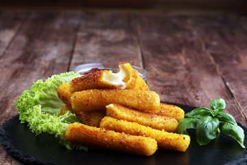 Breaded mozzarella cheese sticks with tomato ketchup and bbq sauce