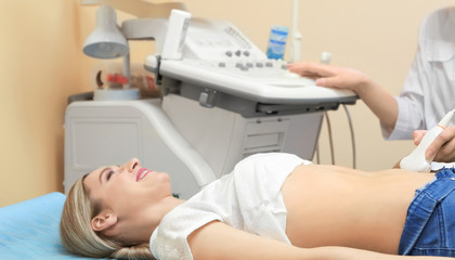 Young woman undergoing ultrasound scan in modern clinic