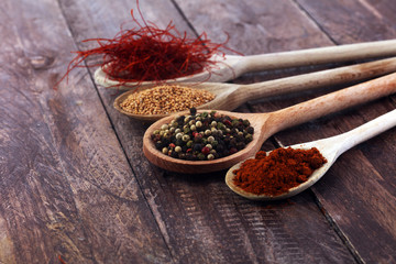 Various colorful spices on wooden table