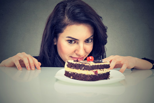 Woman craving cake dessert, eager to eat sweet food