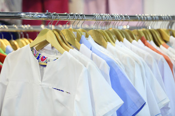 Medical uniform on a hangers in a shop