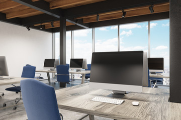 Office with metal pillars, one computer