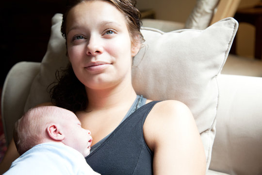 Mother smiles at her newborn