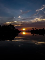 sunsets behind the pond.
