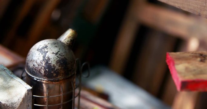 Bee smoker on wooden plank