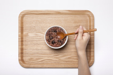 woman hand hold a wood spoon with tray isolated white.