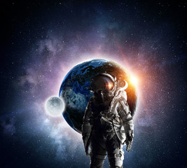 Obraz na płótnie Canvas Astronaut in outer space. Mixed media . Mixed media