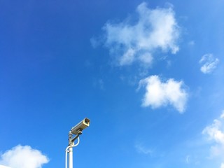 CCTV security camera on the beautiful blue sky background