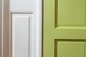 Close up of green interior door with white casing

