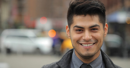 Young Hispanic Latino man in city face portrait