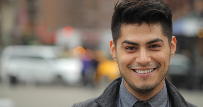 Young Hispanic Latino man in city face portrait