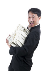 The young businessman stand sideways to the right and turned to laughing with a large amount of money in his arms