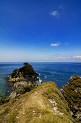 Hidden beauty of Kapas Island located in Malaysia with unique rocks formation and blue sky.