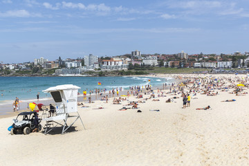 Fototapeta na wymiar People swimming and sun bathing at Bondi Beach, Sydney on a sunny day