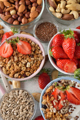 Muesli, nuts, yogurt and cereals on a white background
