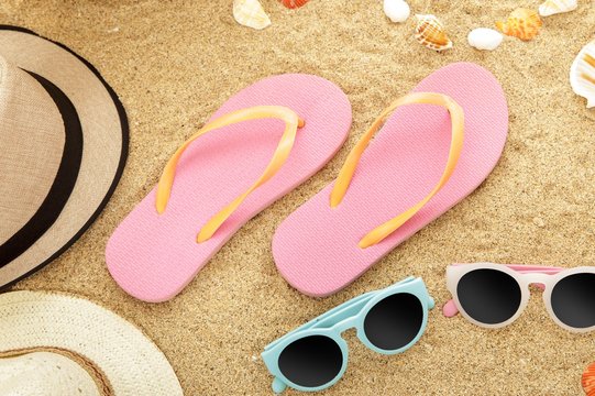 flip flops and sunglasses on beach sands
