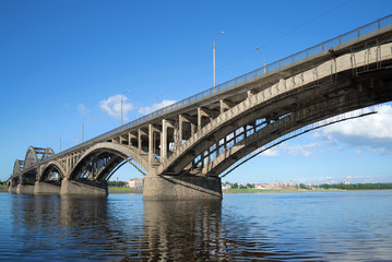Fototapeta na wymiar Automobile bridge across the Volga River in the city of Rybinsk close up on a sunny July day. Yaroslavl Region, Russia