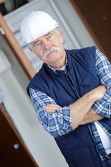 portrait of confident worker with arms crossed