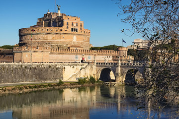 Fototapeta premium Castle of Holy Angel (Castel Sant Angelo) and Holy Angel Bridge over the Tiber River in Rome at sunny winter day. Rome. Italy