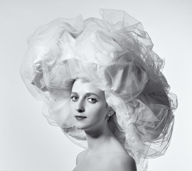 Portrait of a woman in a big white hat.