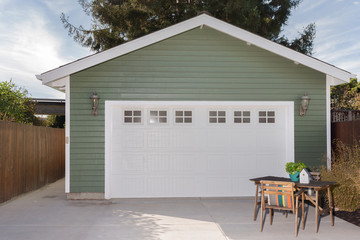 Naklejka premium Green house exterior with white garage door