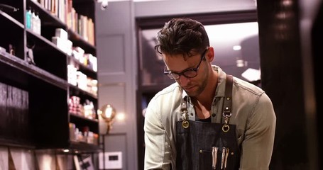 Male barber working in barber shop