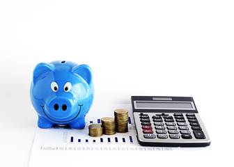 Fototapeta premium Blue piggy bank and calculatr money coins for loans concept
