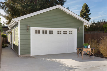 Obraz premium Side view of house exteriors and garage entrance