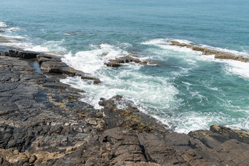 Rocky coast in Goa, India, on a sunny day