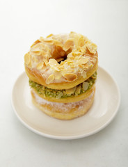 three variant donuts stacked on white plate